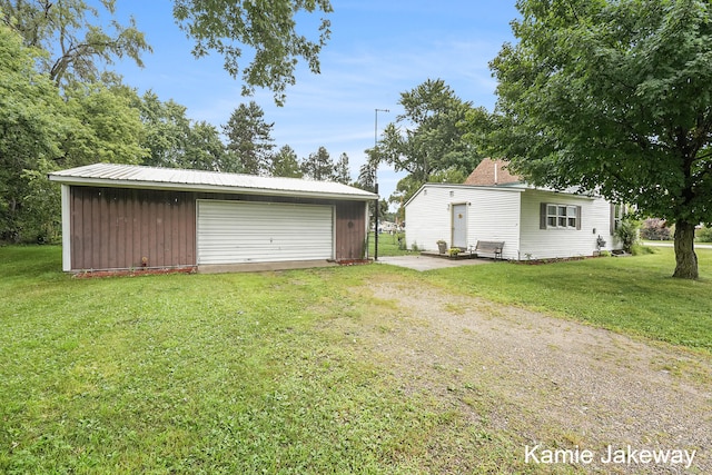 exterior space featuring a garage and an outbuilding