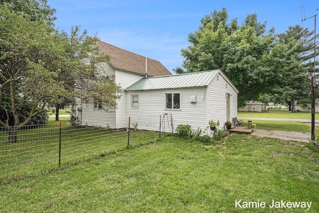 rear view of house with a yard