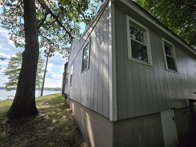 view of side of home with a water view