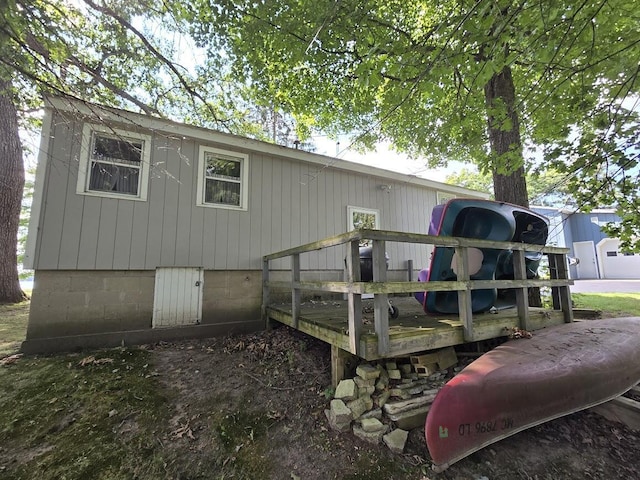 rear view of house featuring a wooden deck