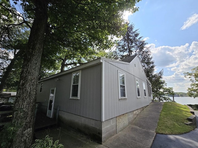 view of side of home with a water view