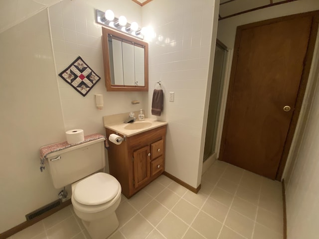 bathroom featuring visible vents, toilet, a shower stall, vanity, and tile patterned flooring