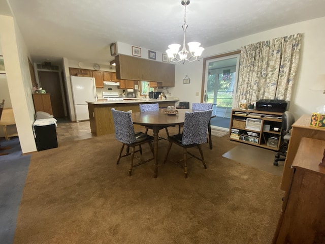 dining space featuring dark carpet and a notable chandelier