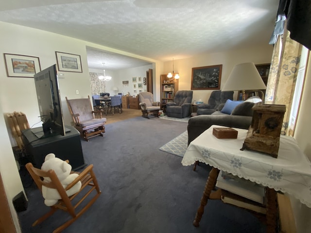 carpeted living area with a notable chandelier and a textured ceiling