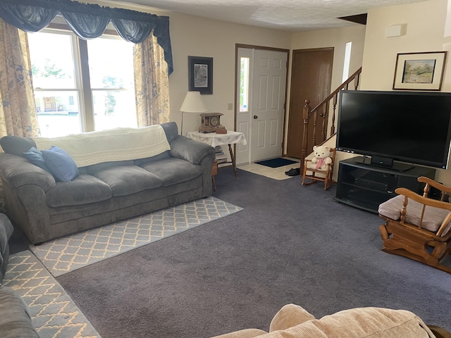 living area featuring carpet and a textured ceiling