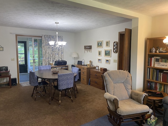 dining room with carpet, a textured ceiling, and an inviting chandelier