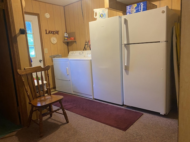 washroom with wood walls and washer and clothes dryer