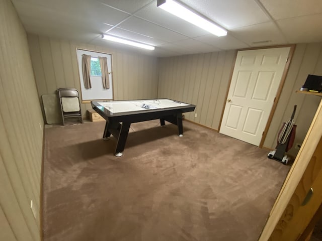 rec room with carpet floors and a paneled ceiling