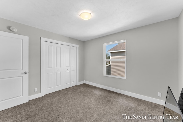 unfurnished bedroom featuring carpet flooring and a closet