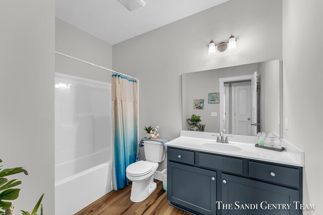 full bathroom featuring shower / bath combo, toilet, vanity, and hardwood / wood-style floors