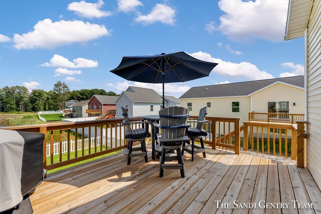 wooden terrace featuring a grill