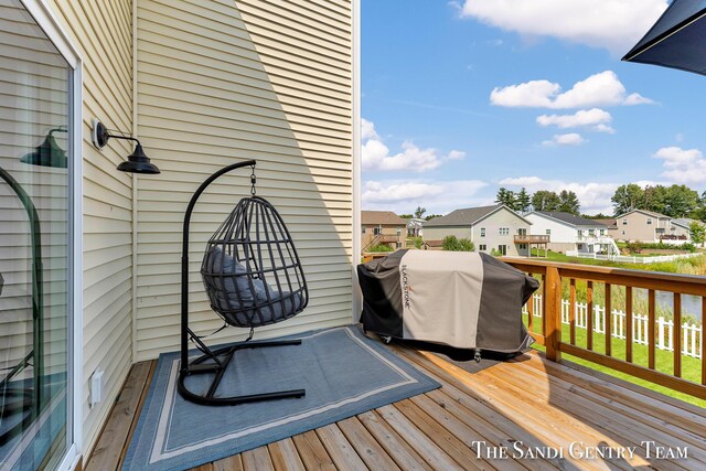 wooden terrace with a grill