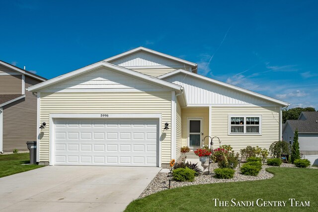 view of front of property with a front yard and a garage