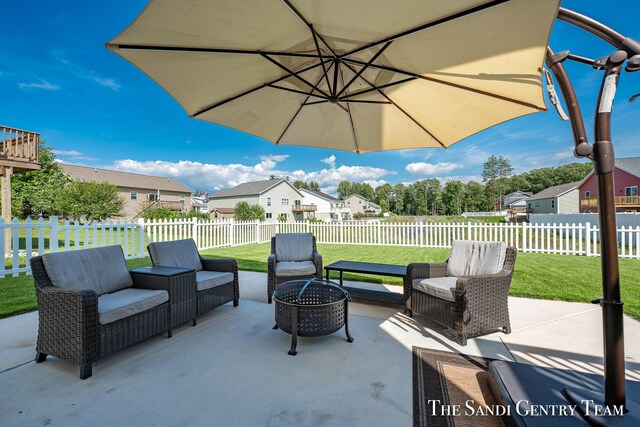 view of patio with an outdoor living space with a fire pit