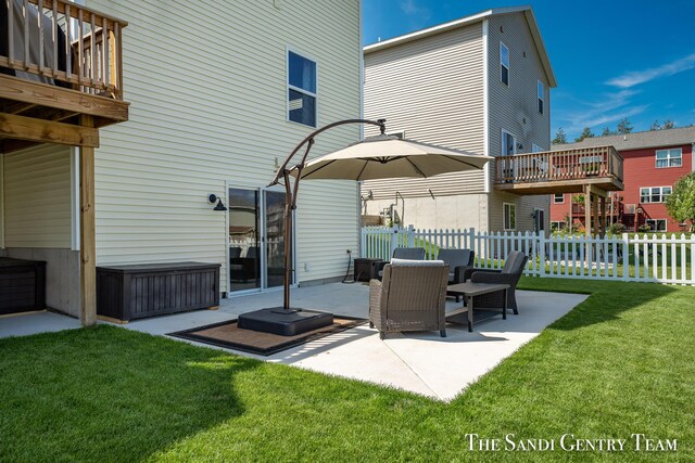 back of house featuring a patio, a deck, and a yard