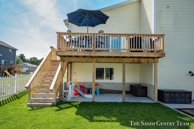 rear view of property with a patio, a deck, and a lawn