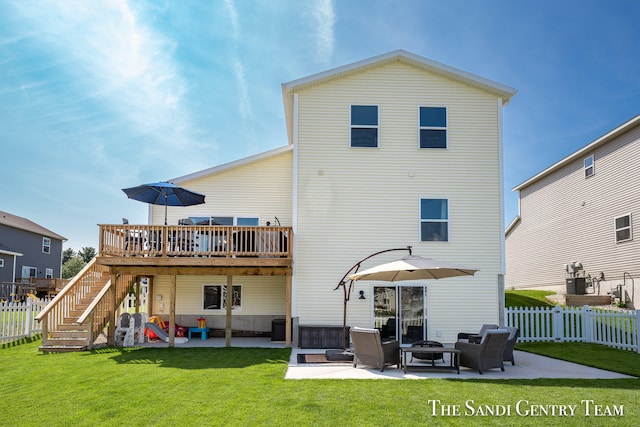 back of house featuring an outdoor living space, central air condition unit, a yard, a wooden deck, and a patio area