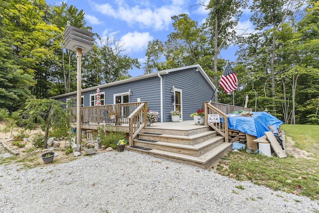 rear view of property with a wooden deck