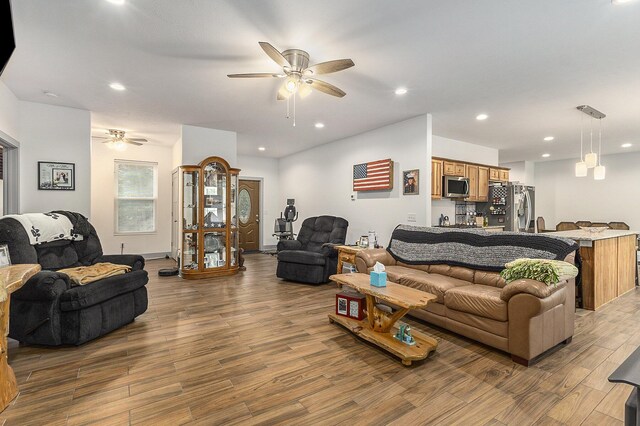 living room featuring ceiling fan and wood-type flooring