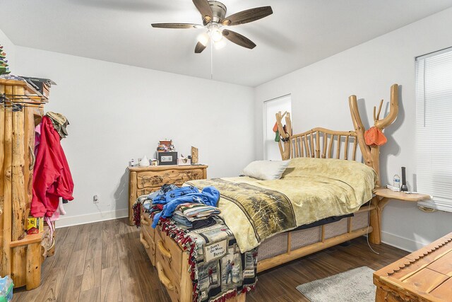 bedroom with ceiling fan and dark wood-type flooring