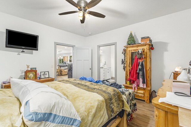 bedroom featuring ceiling fan, wood-type flooring, and connected bathroom