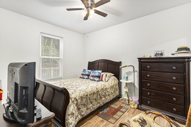 bedroom with ceiling fan and light hardwood / wood-style floors