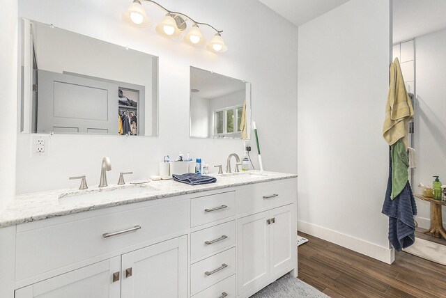 bathroom featuring dual vanity and hardwood / wood-style floors