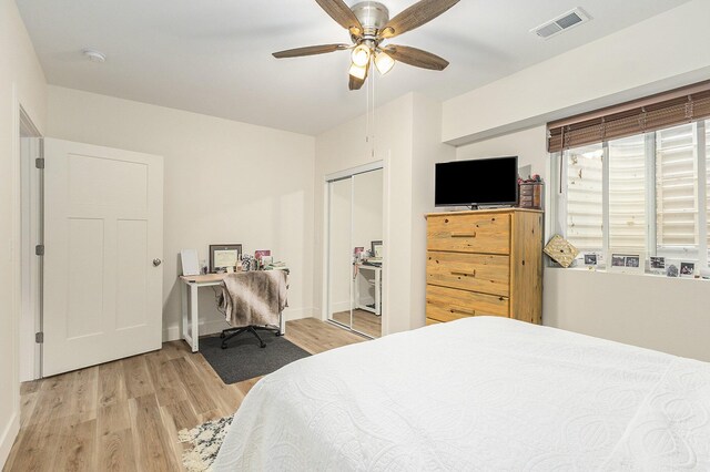 bedroom with light wood-type flooring, a closet, and ceiling fan