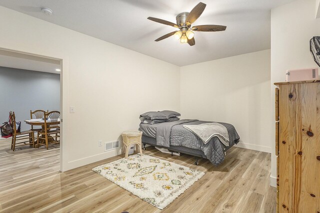 bedroom with light wood-type flooring and ceiling fan