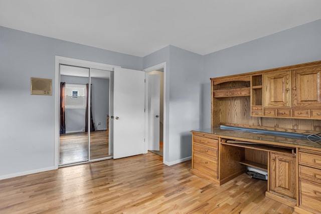 office featuring light wood-type flooring and baseboards