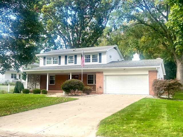 view of front of house featuring a garage, brick siding, concrete driveway, and a front yard