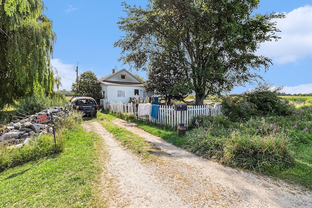 exterior space with a fenced front yard and driveway