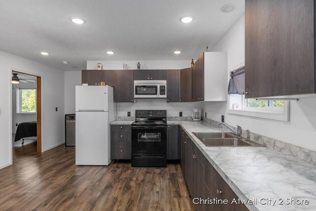 kitchen featuring white fridge, sink, dark hardwood / wood-style floors, black electric range oven, and ceiling fan