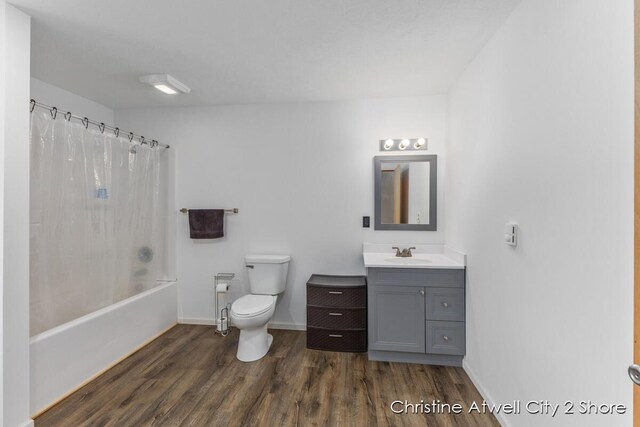 full bathroom with toilet, hardwood / wood-style floors, vanity, and shower / tub combo with curtain