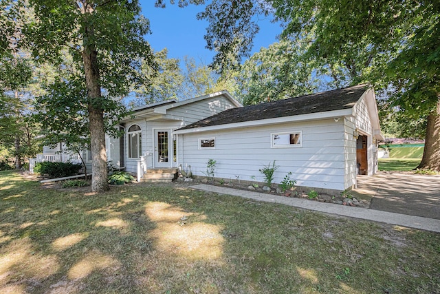 ranch-style home with a garage and a front lawn