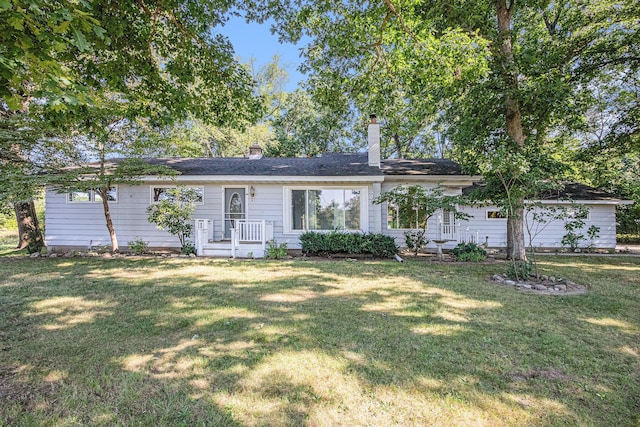 single story home featuring a front yard and a chimney