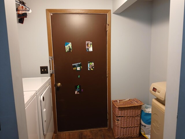 laundry room featuring laundry area, washing machine and dryer, and wood finished floors