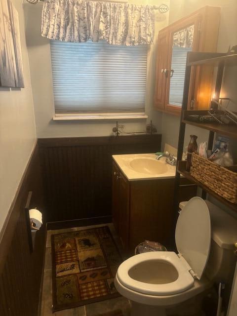 bathroom featuring tile patterned floors, vanity, and toilet