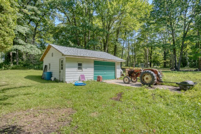 exterior space with a garage and a lawn