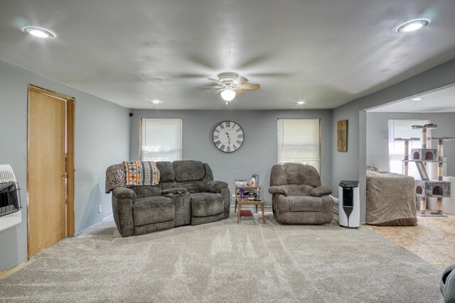 carpeted living room featuring ceiling fan