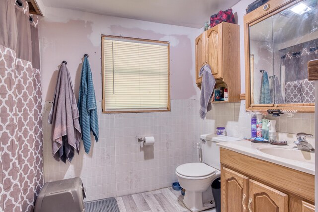 bathroom featuring decorative backsplash, vanity, tile walls, toilet, and hardwood / wood-style flooring