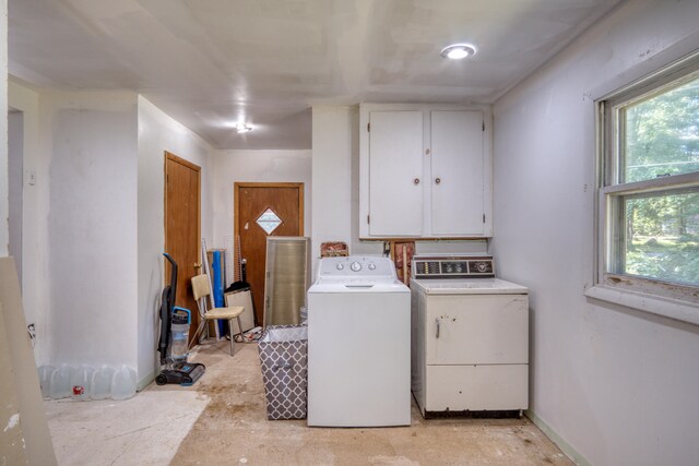 washroom featuring washer / clothes dryer and cabinets