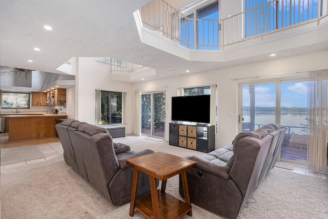 tiled living room featuring plenty of natural light and a high ceiling