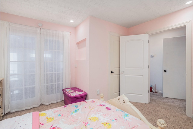 unfurnished bedroom with a textured ceiling and light colored carpet