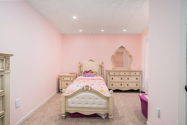 bedroom featuring carpet flooring and a textured ceiling