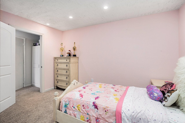 carpeted bedroom featuring a textured ceiling