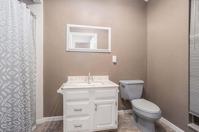 bathroom with vanity, toilet, and tile patterned flooring