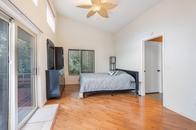 bedroom with access to outside, high vaulted ceiling, light wood-type flooring, and ceiling fan