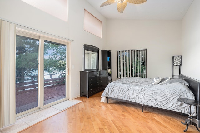 bedroom with ceiling fan, high vaulted ceiling, light hardwood / wood-style flooring, and access to outside