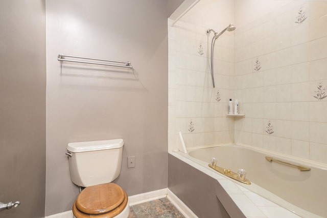 bathroom with tiled shower / bath combo, tile patterned flooring, and toilet